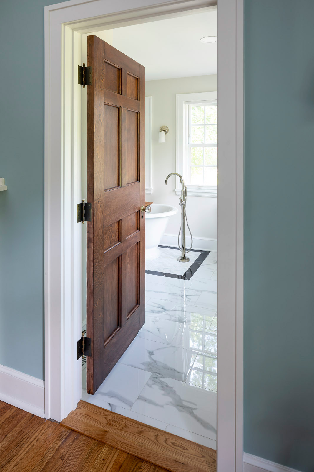 panel door with glass knob and antique hinges