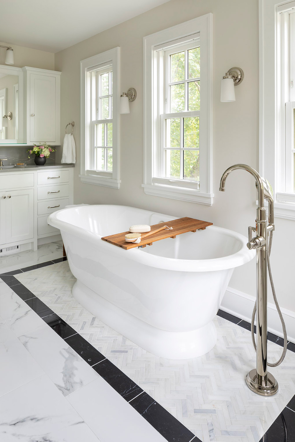 freestanding tub on herringbone tile rug